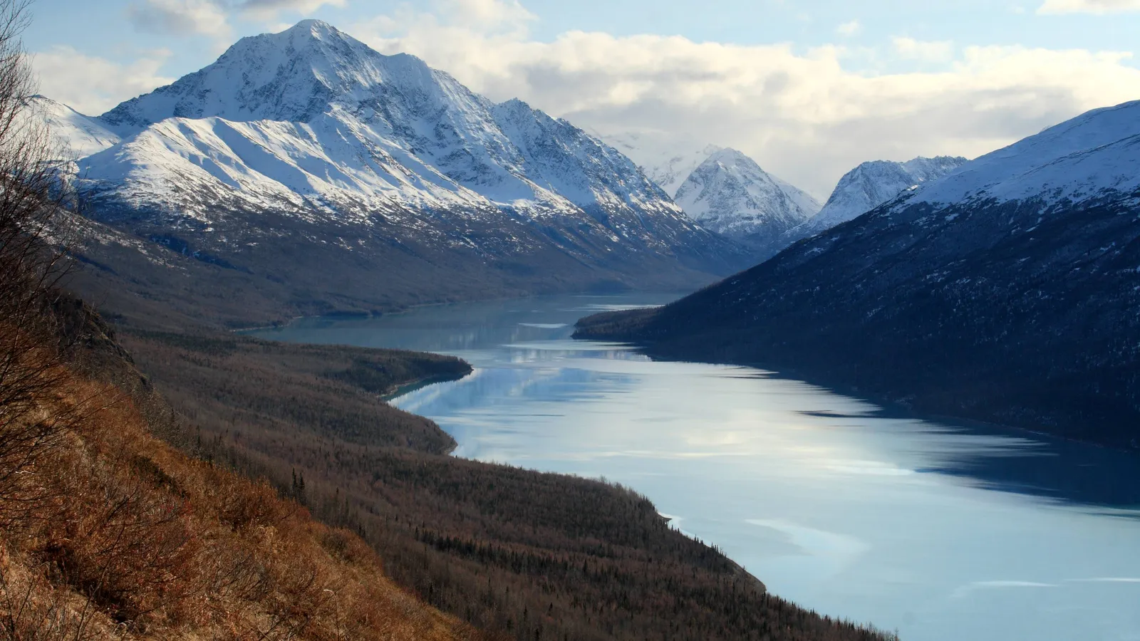 Eklutna Lake winding between snow-capped peaks, seen from the Twin Peaks trail