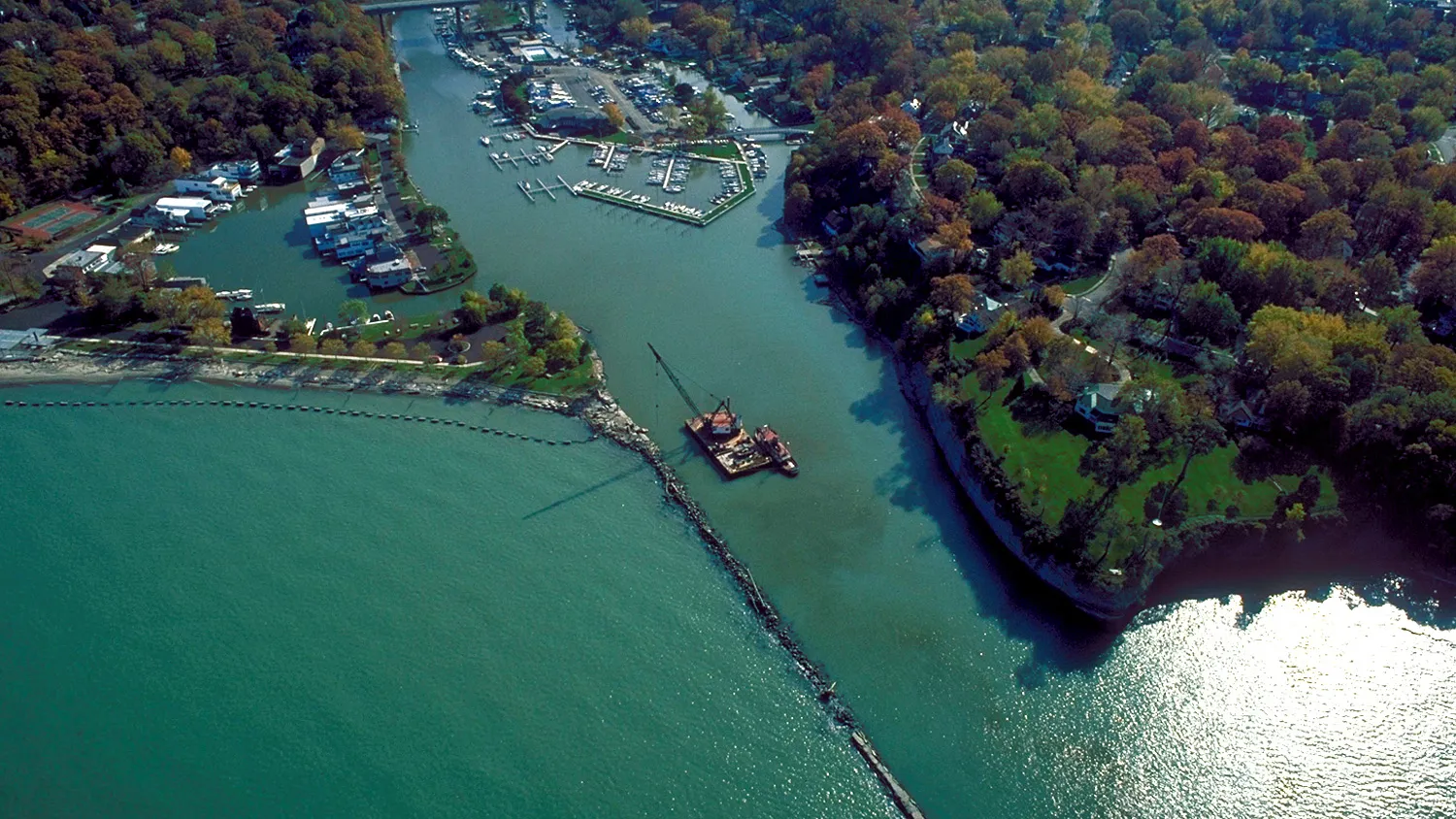 Aerial view of the Rocky River meeting Lake Erie, with marinas along the river