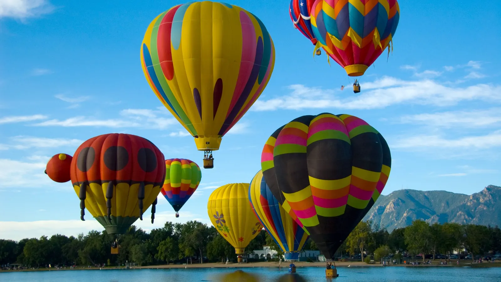 Hot air balloons lifting off over Prospect Lake in Memorial Park