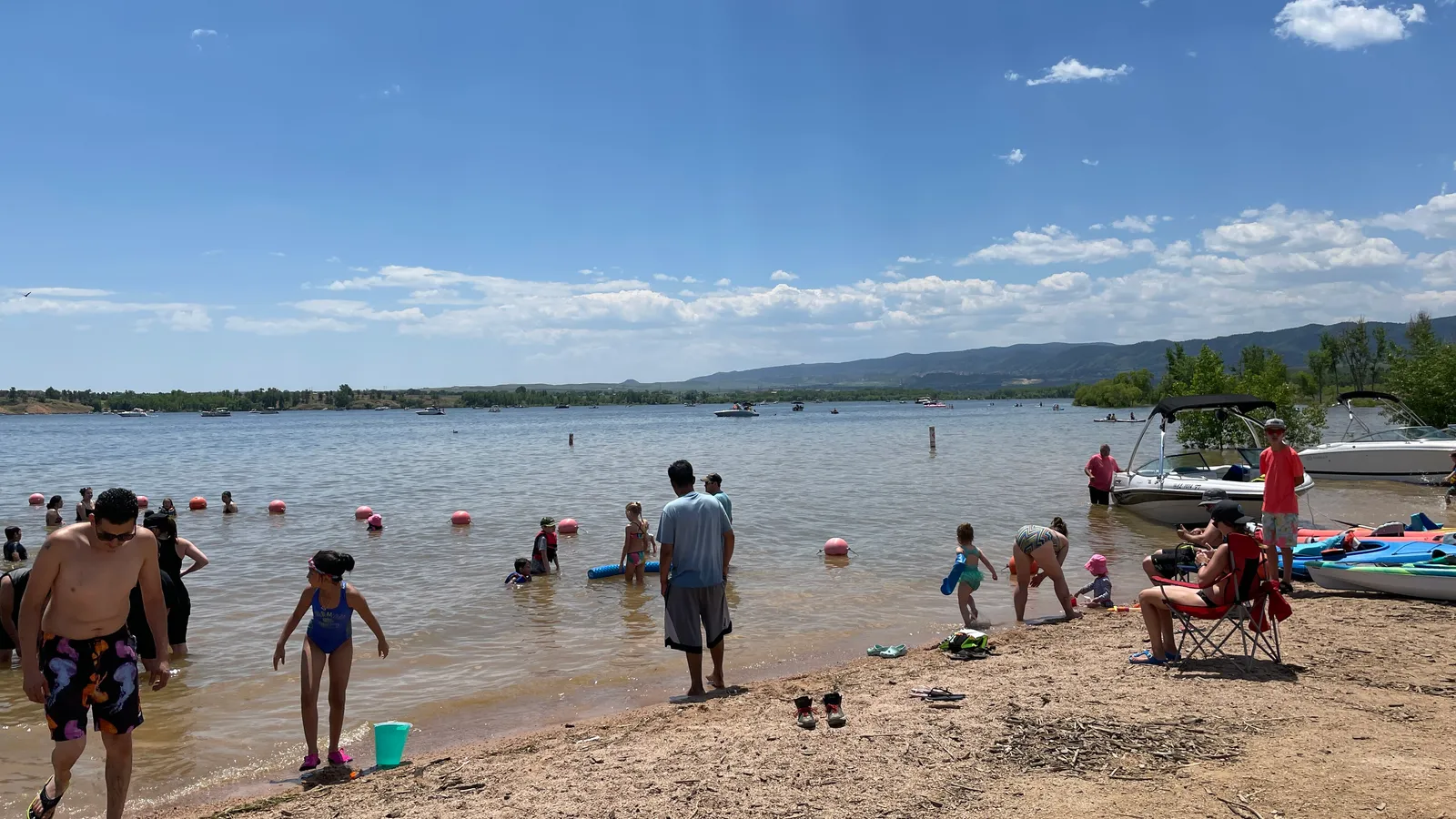 The swim beach at Chatfield Reservoir on a summer day, with kayaks on the shore
