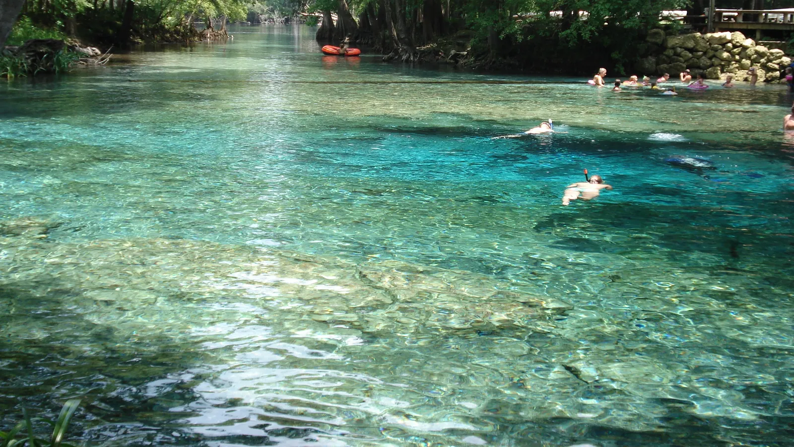 Swimmers and tubers in the clear turquoise water of Ginnie Springs