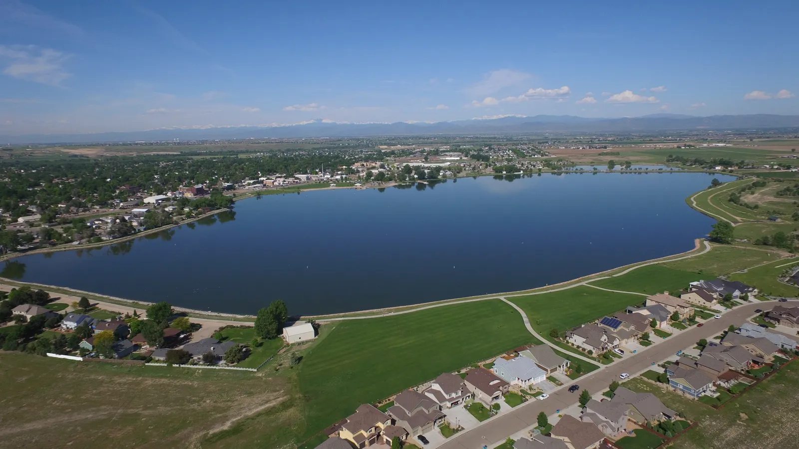 Aerial view of Windsor Lake with the town of Windsor and the Front Range behind