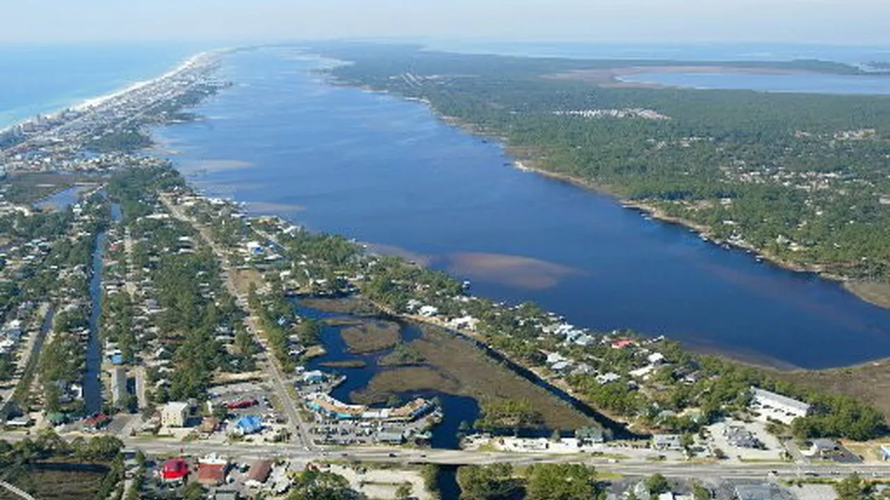 Aerial view of Little Lagoon, a long saltwater lagoon behind the Gulf Shores beachfront