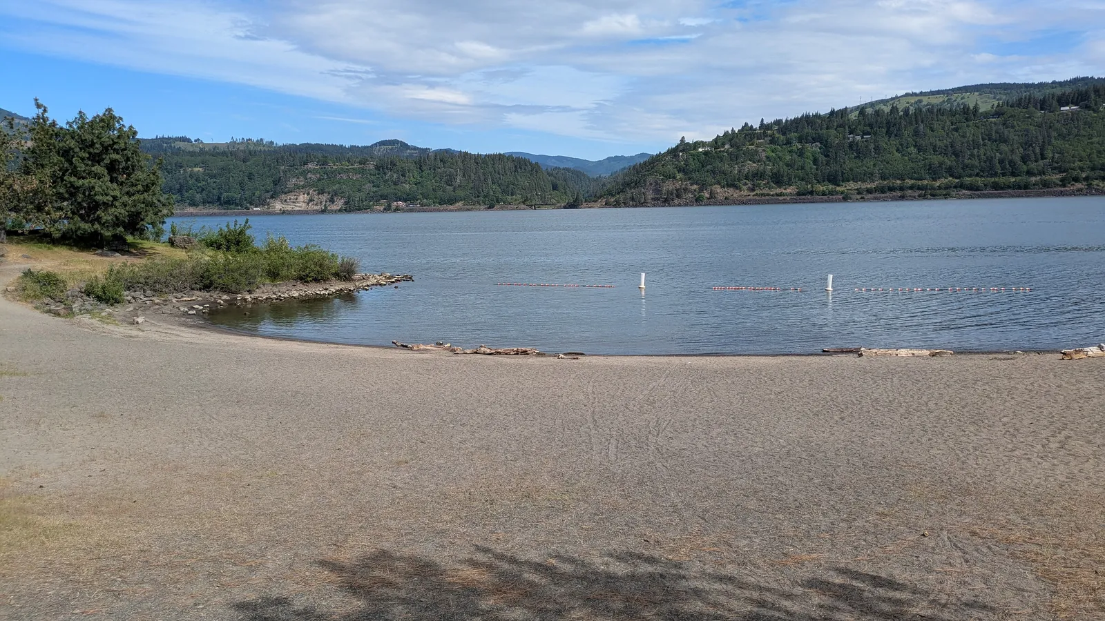 The sandy swim beach at Hood River Waterfront Park, with the Columbia River and Washington hills behind