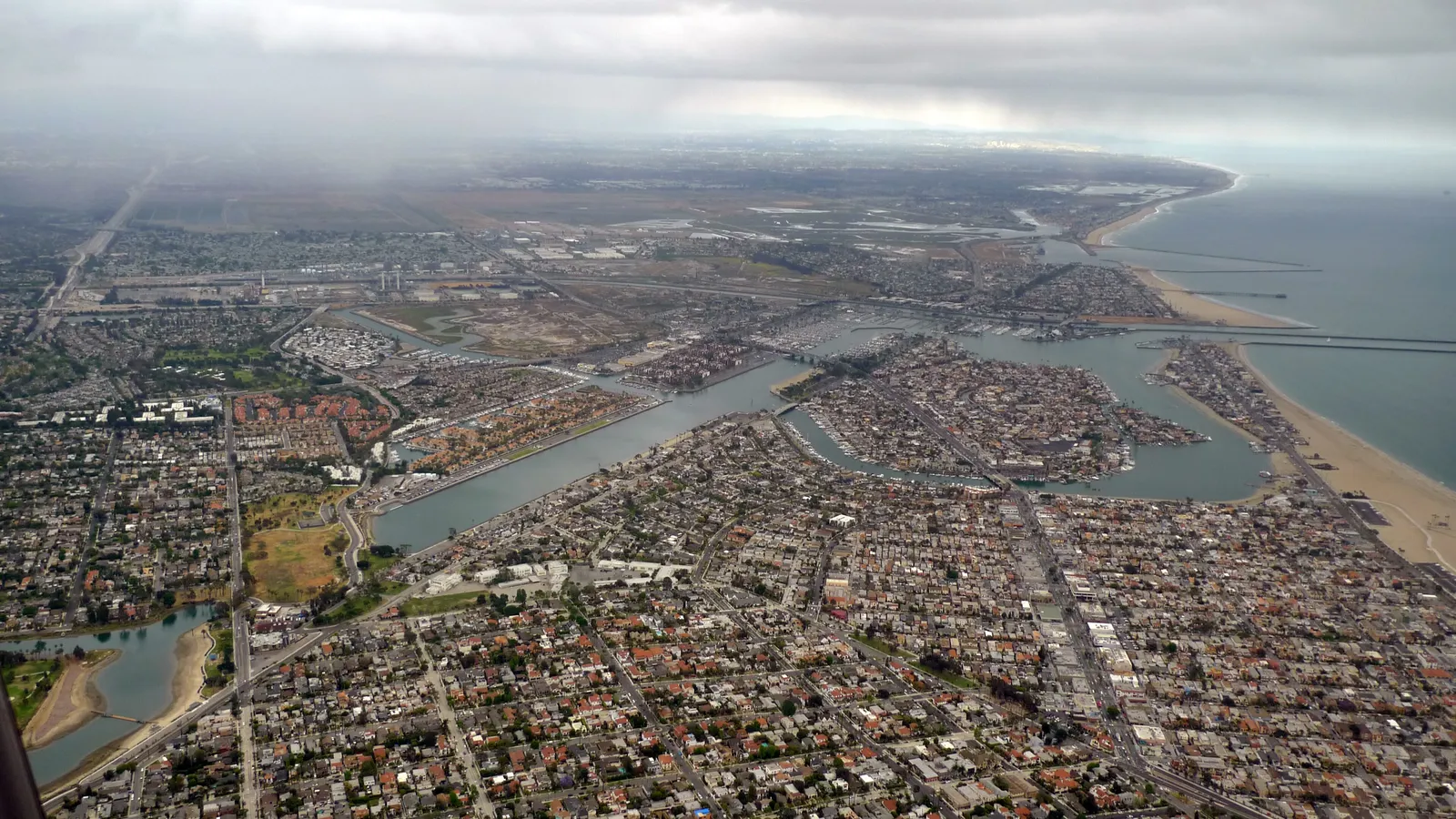 Aerial view of Alamitos Bay and the Naples islands in Long Beach, with the coast beyond