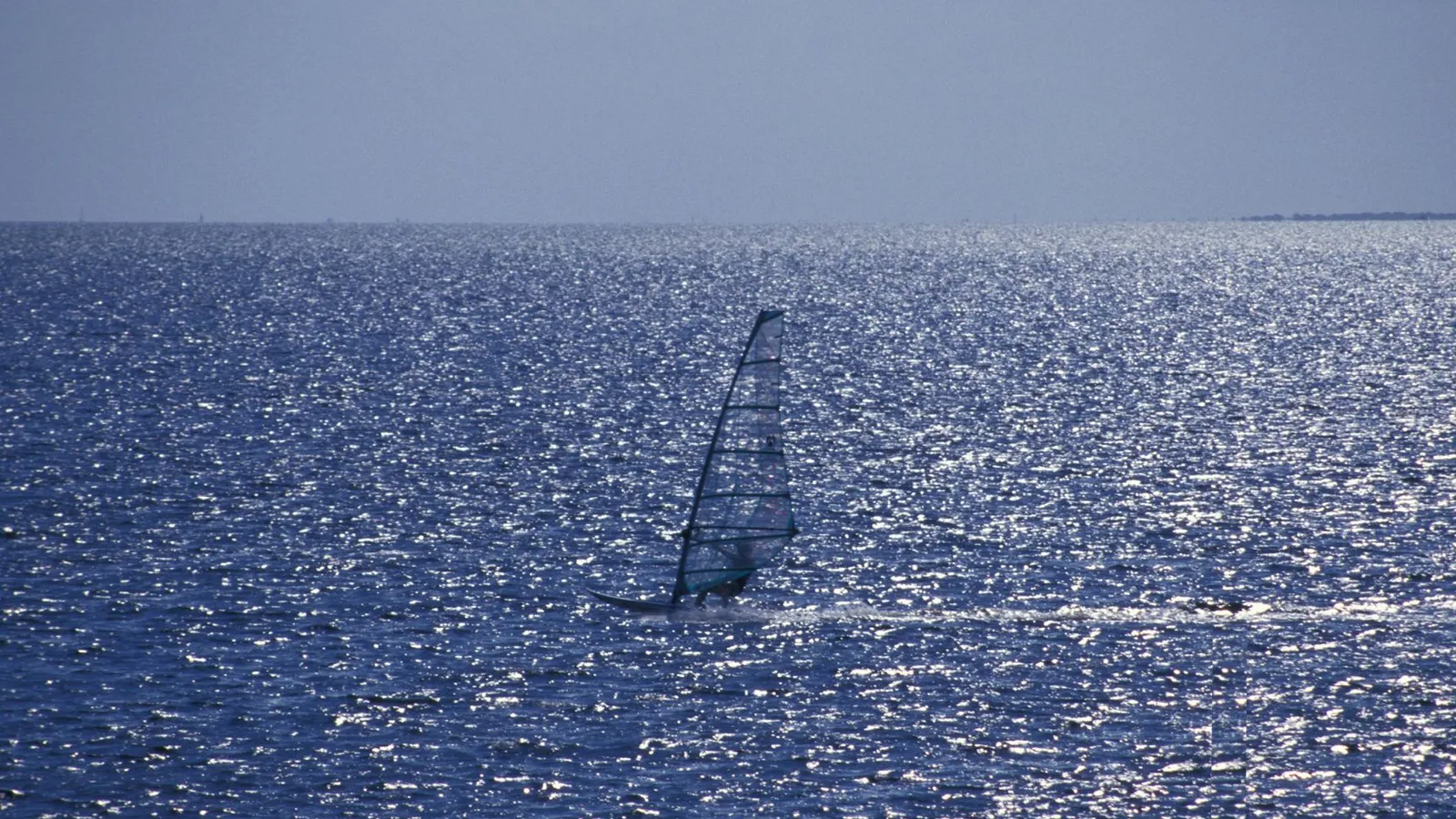 A windsurfer on sparkling Biscayne Bay off Convoy Point in Biscayne National Park