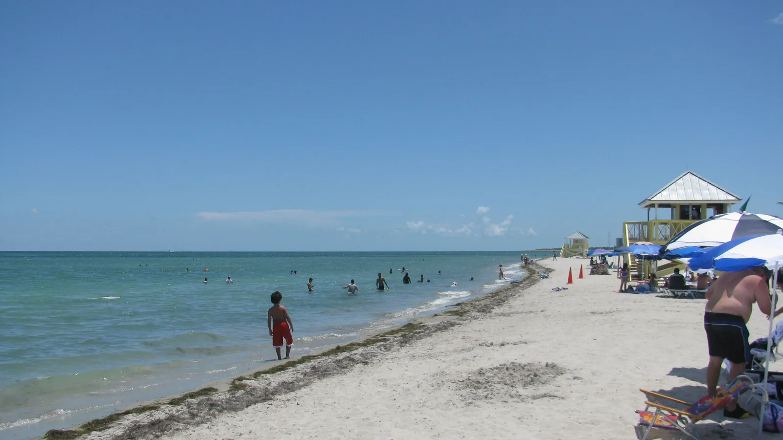 Swimmers in shallow water along the beach at Crandon Park on Key Biscayne