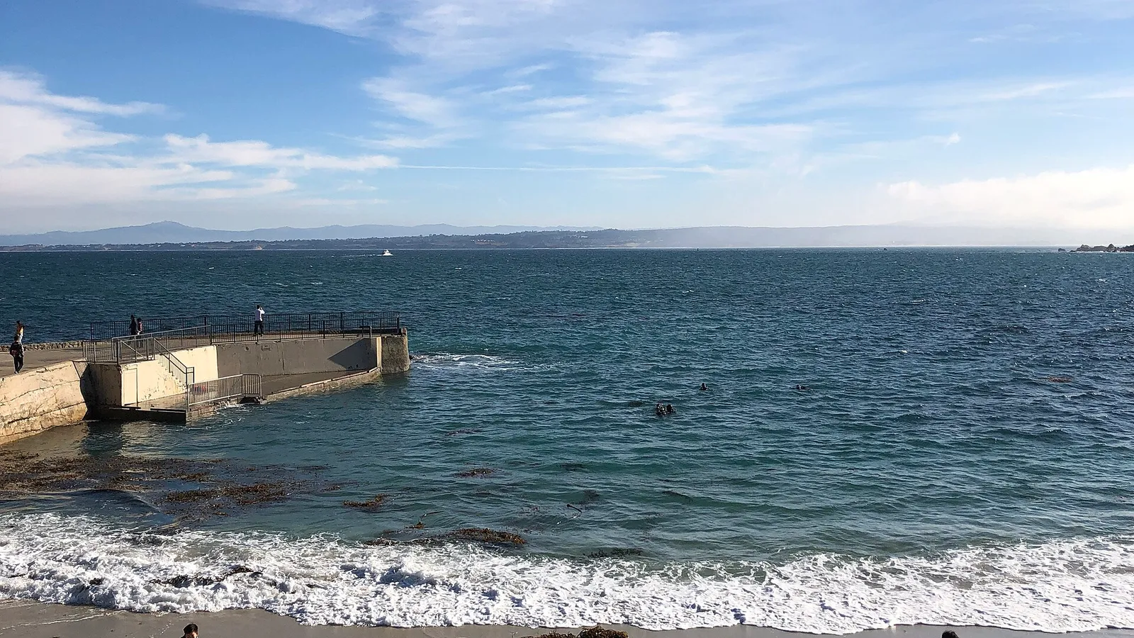 The small sheltered beach and pier at Lovers Point in Pacific Grove