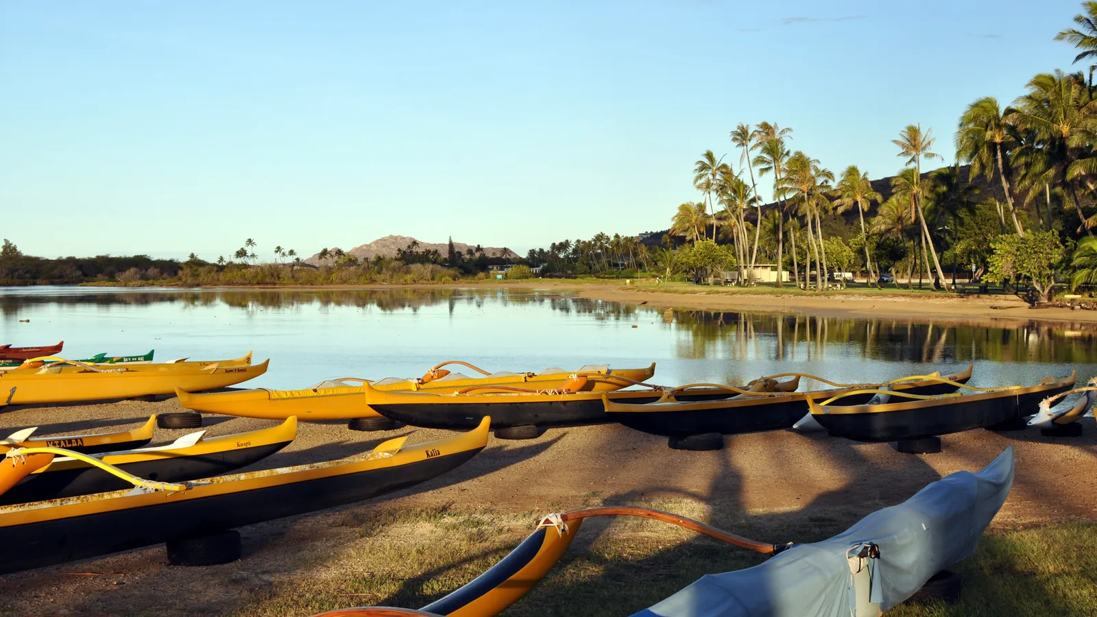 Outrigger canoes on the shore of Maunalua Bay, with Koko Head behind