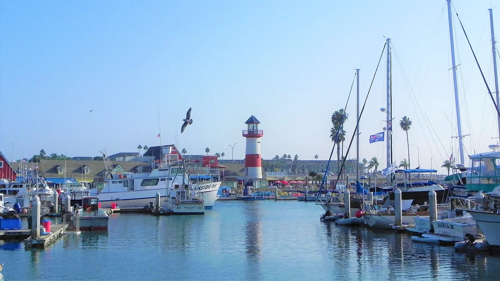 Boats and the lighthouse at Oceanside Harbor Village