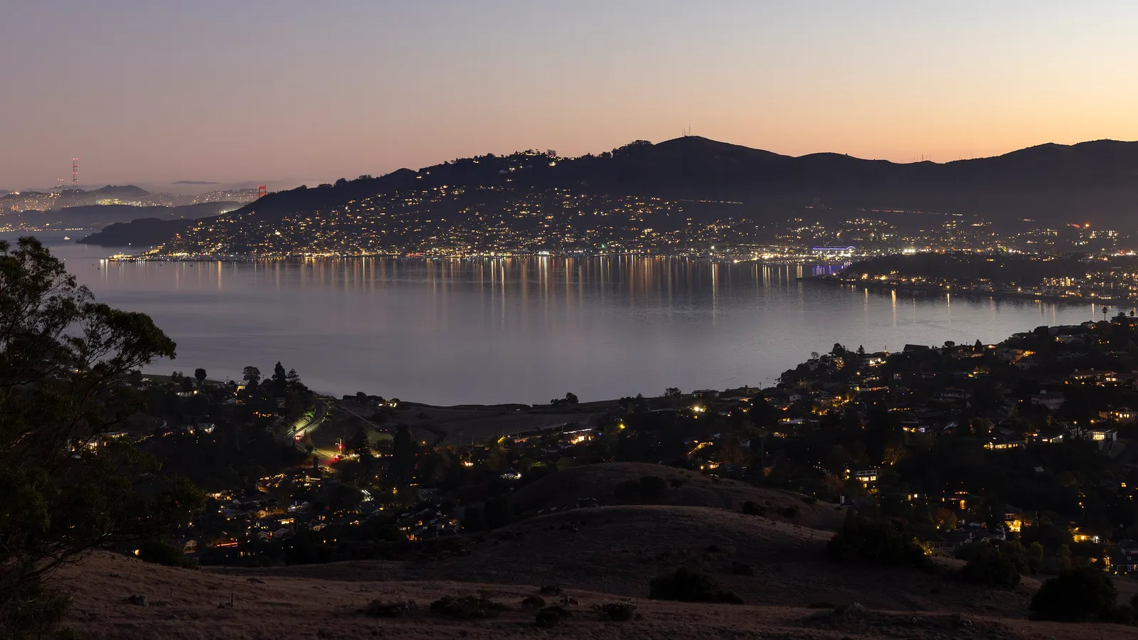 Richardson Bay and the lights of Sausalito at dusk, seen from the hills
