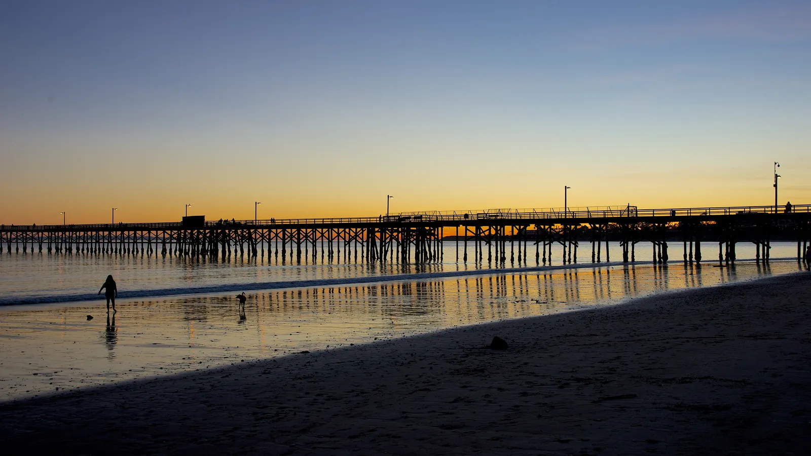 Goleta Pier stretching out from the beach at sunset