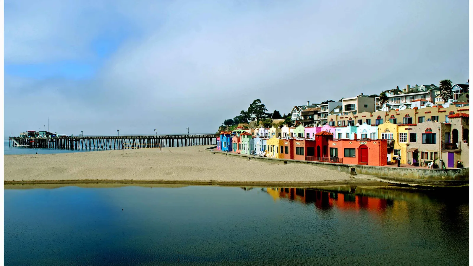 Capitola Beach and its colorful Venetian buildings, with the Capitola Wharf behind