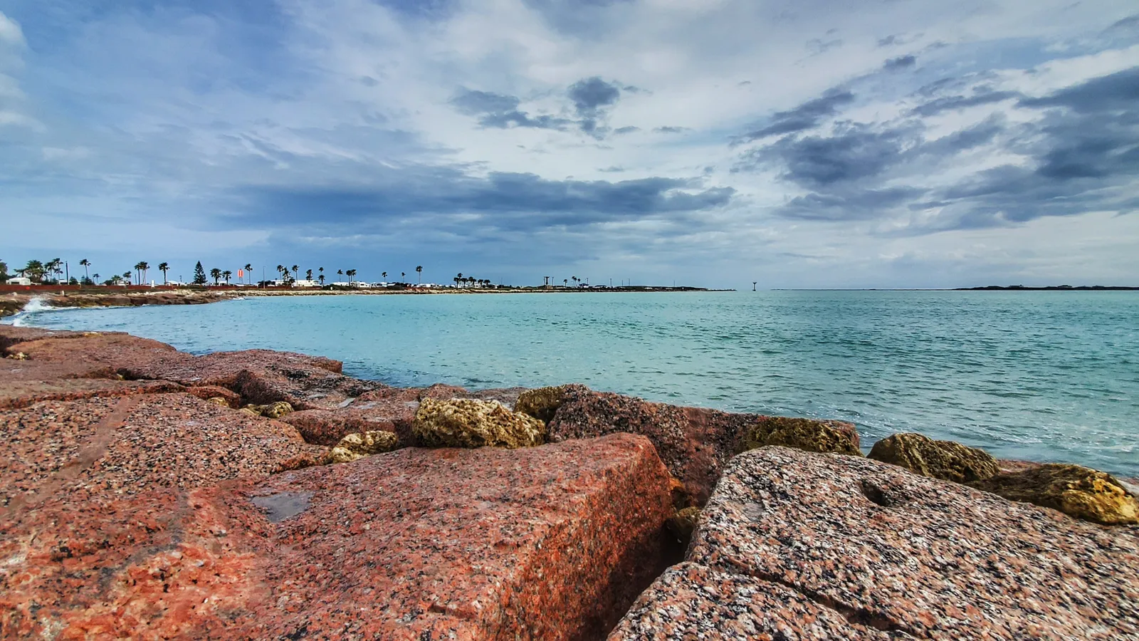 Granite rocks and calm, clear water on the bay side of Isla Blanca Park