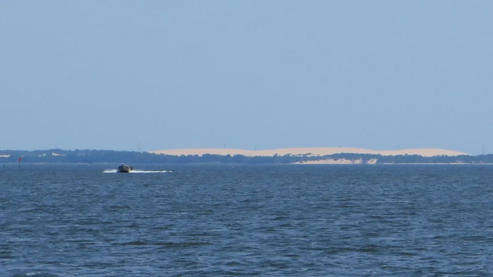 The pale dunes of Jockey's Ridge seen across Roanoke Sound