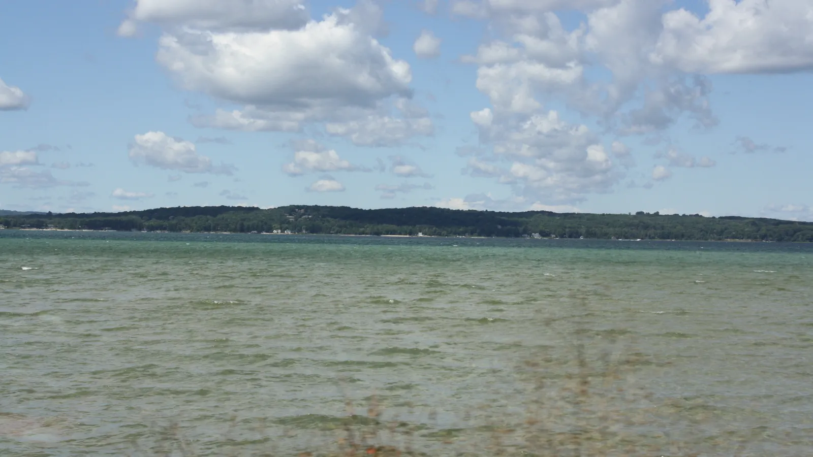 Green water on the east arm of Grand Traverse Bay under summer clouds