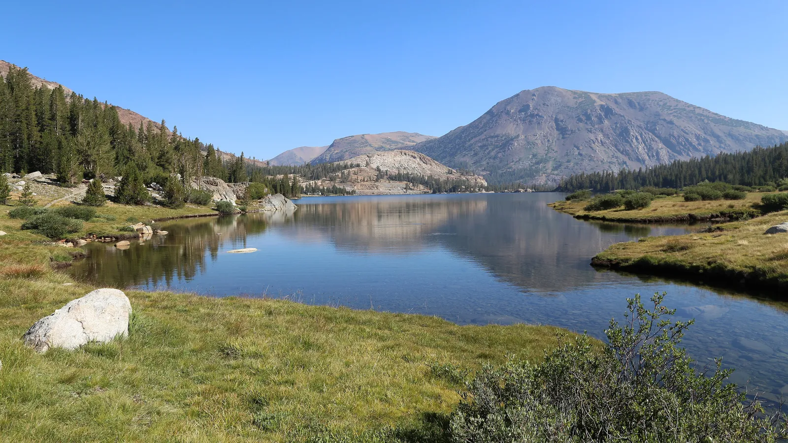 Tioga Lake and the peaks above Tioga Pass on a clear summer day