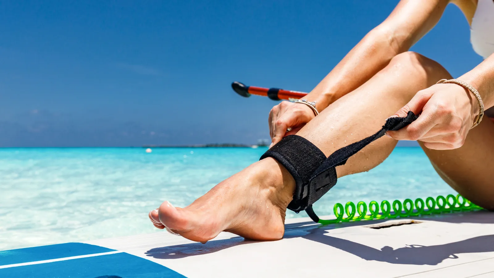 Paddle board leash attached to an ankle