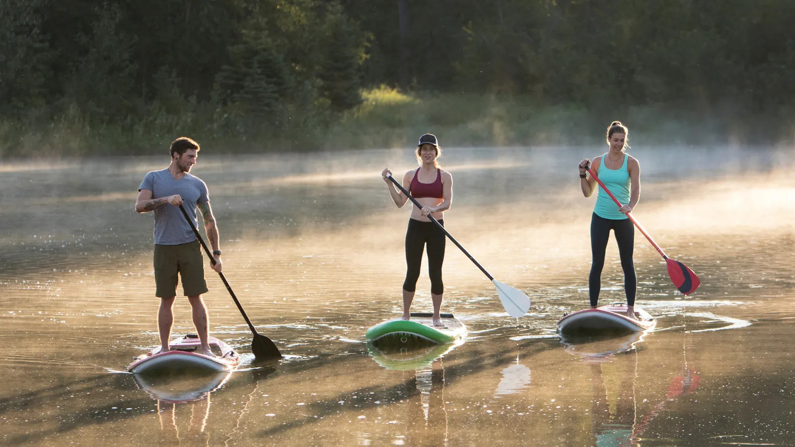Recreational paddle boarders on calm water